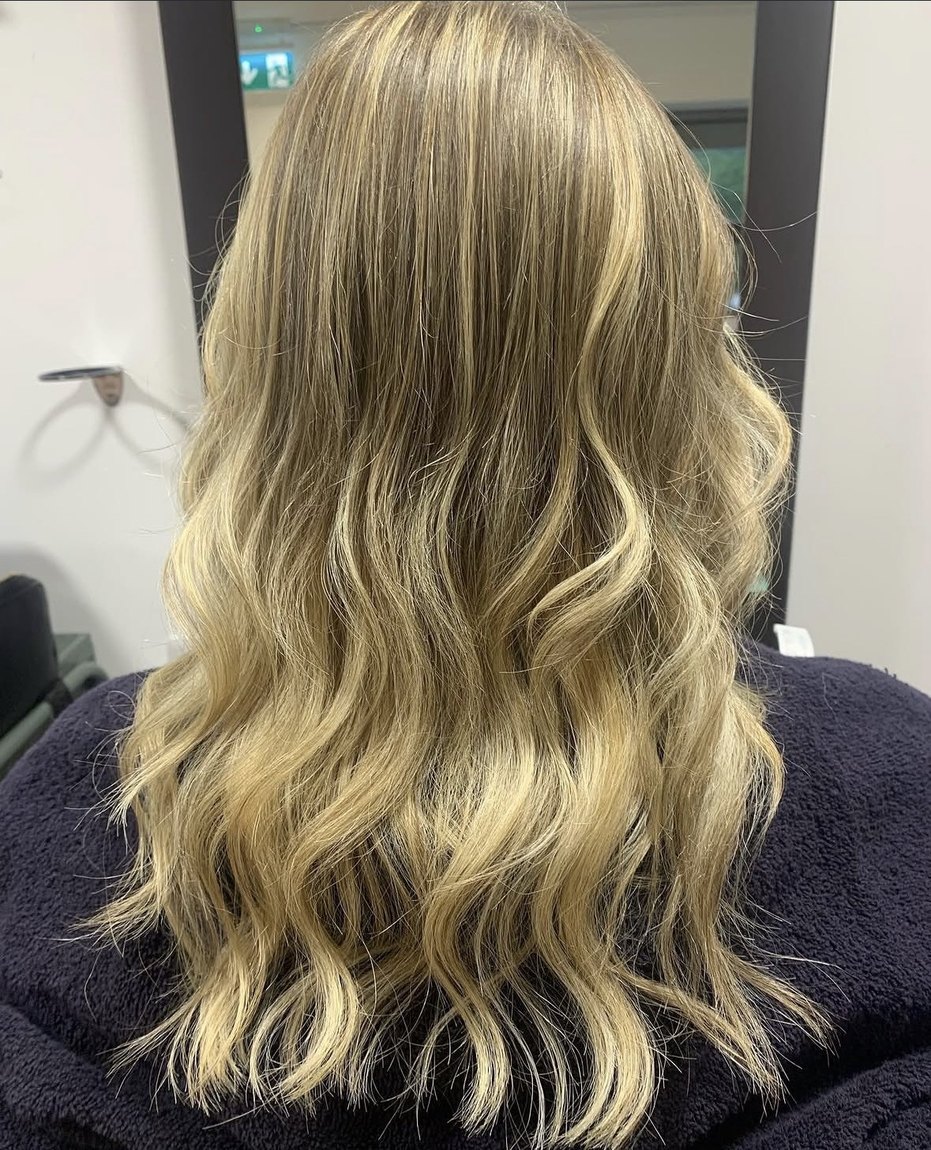 Glossy blonde waves after colour at INCH Hair Design